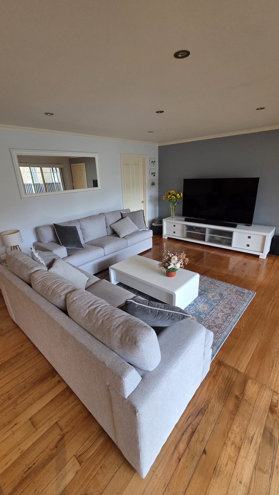A comfortable lounge room with couches and a TV